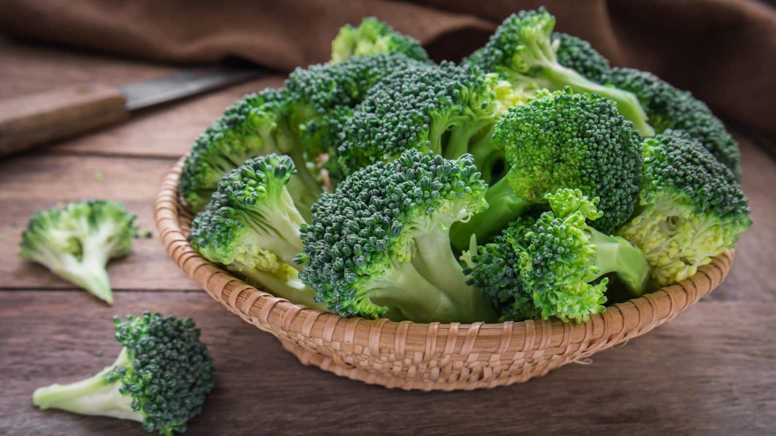 broccoli florets in a beige colored bowl